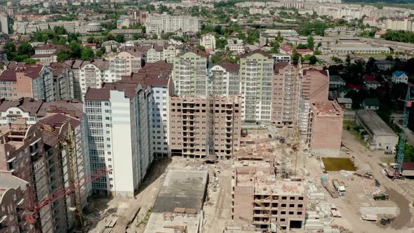 Aerial Drone View of Construction Building in City. Workers Work on Construction Sites Top View alt