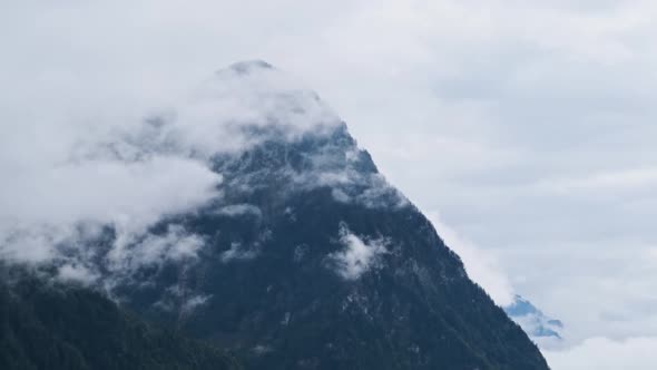 Panoramic View on the Alpine Mountains in the Clouds