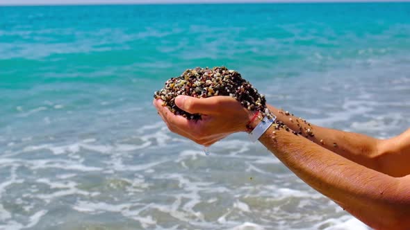 A Man Plays with Stones on the Beach