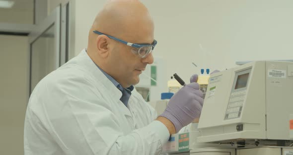 Scientist working with mass spectrometer in a pharmaceutical laboratory conducting experiments