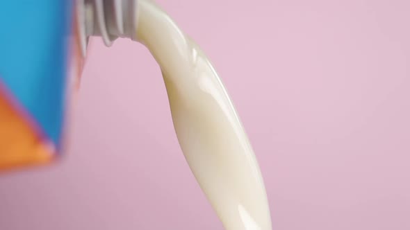 Pouring vegetable oat milk from a pack