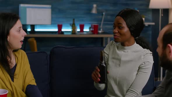 Black Woman Discussing with Her Friends While Holding Beer Bottle