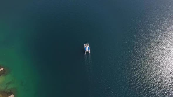 Lone Sailboat on the Sea Surface. Aerial Top View