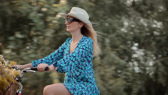 Pretty Woman Walking With Bicycle On Field.Woman Cyclist Walking With Bike On Holiday Vacation Trip.