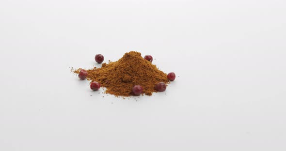 Red Pepper Powder Rotation. Macro Shot Against a White Background