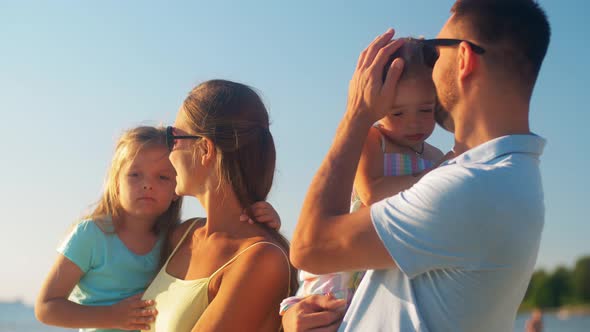 Happy Family with Daughters on Summer Beach