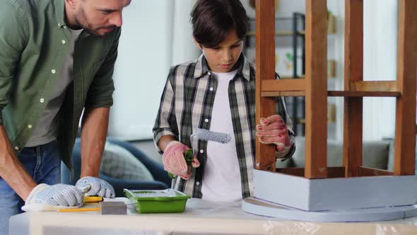 Father and Son Painting Old Table in Grey Color