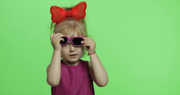 Girl in Purple Dress. Wears Sunglasses and Dance. Happy Child. Chroma Key