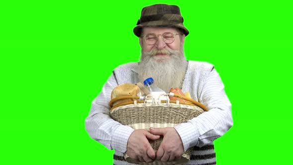 Senior Farmer Holding Basket with Dairy Products