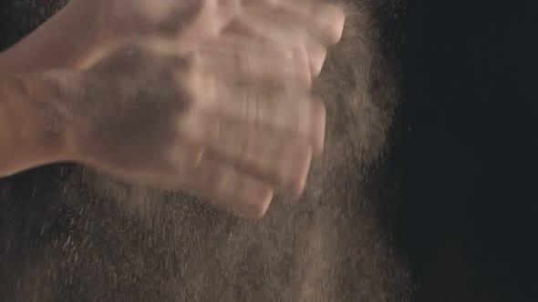Closeup of Male Hands Shaking Off Flour