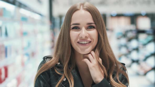 Close-up Portrait of a Positive Beautiful Young Woman Posing in Supermarket