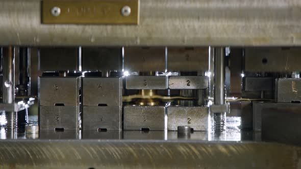 A large industrial punch press forming high precision metal parts for the automotive industry