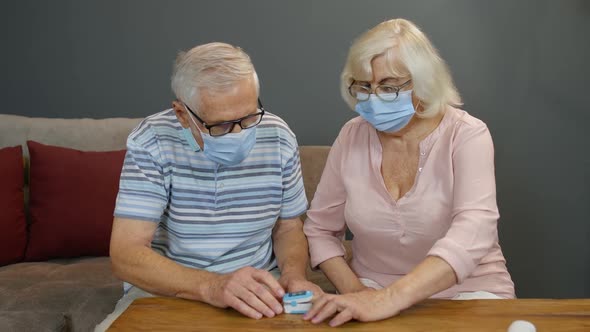 Senior Couple Grandfather and Grandmother Monitoring Oxygen Saturation with Digital Pulse Oximeter