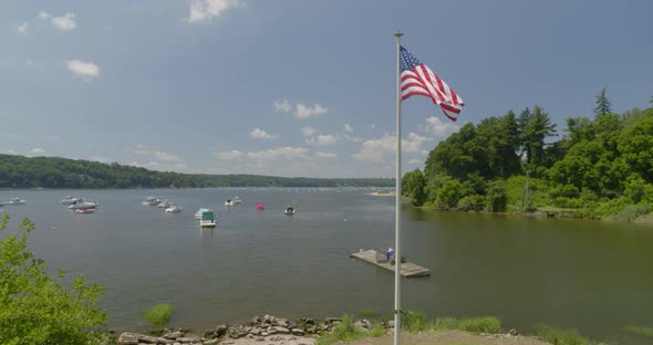 Flying Past American Flag and Towards Boats Anchored on Cold Spring Harbor