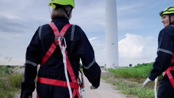 Two maintenance engineers in safety gear working at height walking to the maintenance station