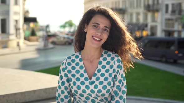 Portrait of Elegant Charming Woman Wearing Dress Smiling While Walking in Downtown on Sunny Day Slow