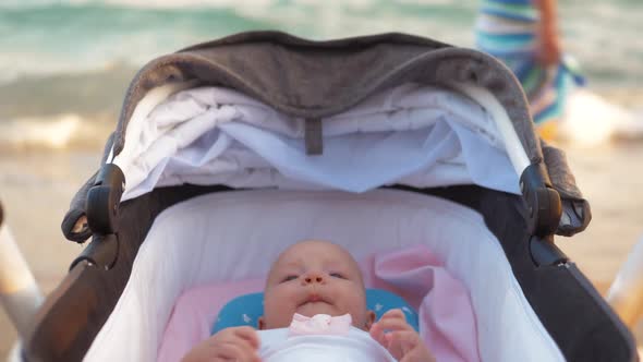 Baby Girl in Pram at the Seaside