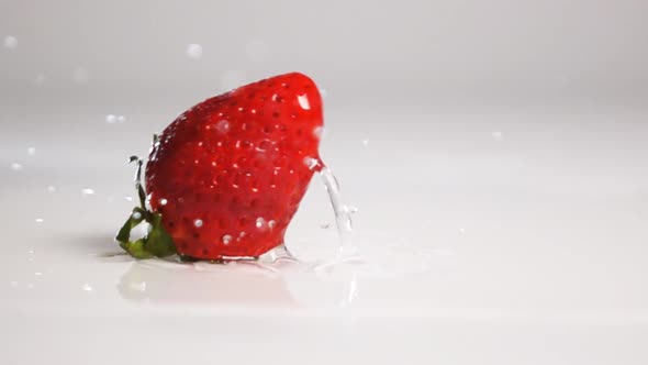 Strawberry Fall on White Wet Surface