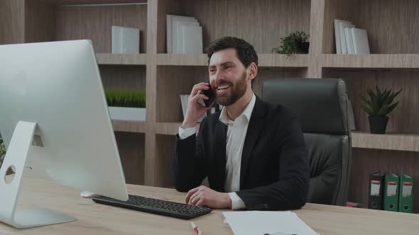 Positive Informal Phone Conversation of Goodlooking Senior Manager at His Workplace in Front of His