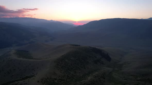 Red Rays of the Sun at Sunset Among the Mountains