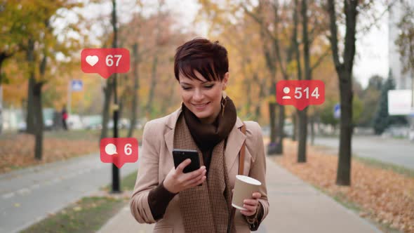 A Woman Uses a Smartphone on the Street.