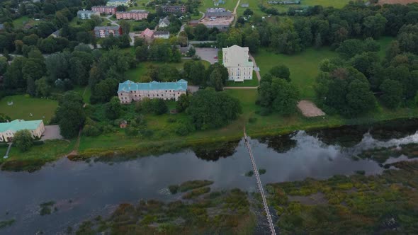 Mezotne Palace and Park With Fountain in Latvia. Lielupe River With Ponton Bridge Aerial 4K