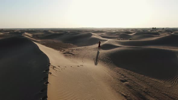 Landscape View of the Amazing Great Sandy Desert in UAE with a Woman Walking