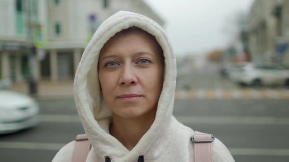 A Beautiful Woman In The City Looks Into The Camera