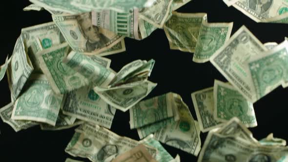 Falling crumpled dollars background. Slowmotion of dollars falling.