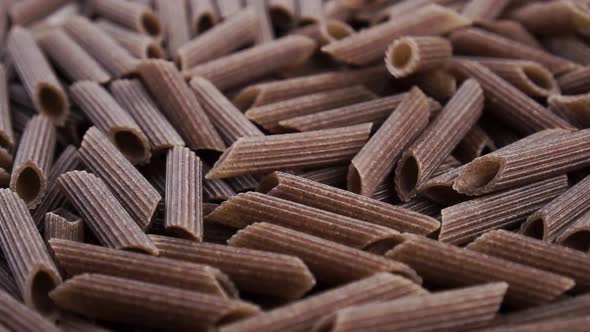 Dry buckwheat italian pasta penne. Falling in slow motion