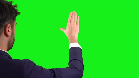 Businessman on green background.