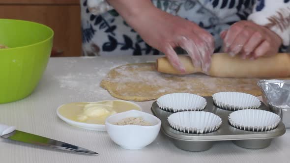 The Woman Rolls Out The Dough. Prepares Cruffin With Raisins And Candied Fruit.