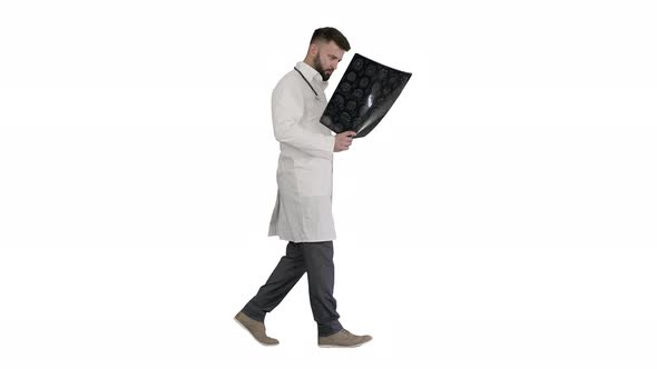 Doctor From Middle East Walking and Looking at Ct Scan on White Background.