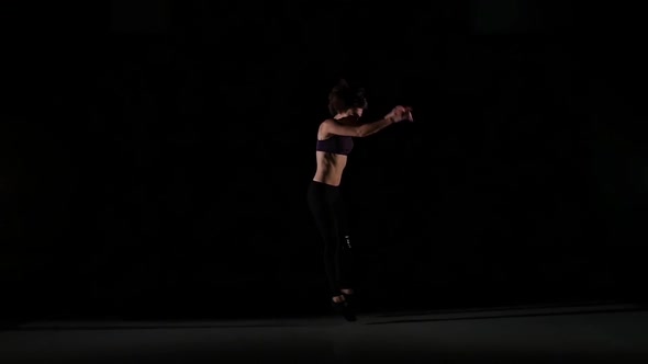 Moves of Girl Dancing Contemp in the Shadow on Black Background, Slow Motion