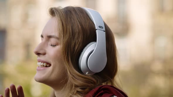 Cheerful Woman Relaxing in Headphones Outdoors, Pretty Girl Face Listening Music