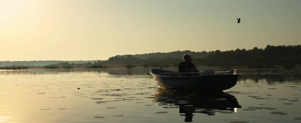 A Young Man Is Traveling By Boat