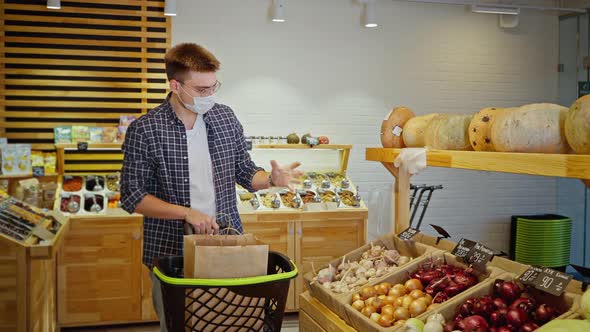 Man Shopper Buying Garlic in the Grocery