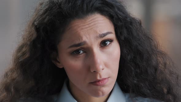 Young Serious Hispanic Brunette Woman with Curly Hair Inquiring Facial Expression Ask Question What