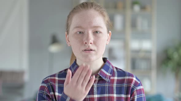 Close Up of Young Woman Giving Flying Kiss