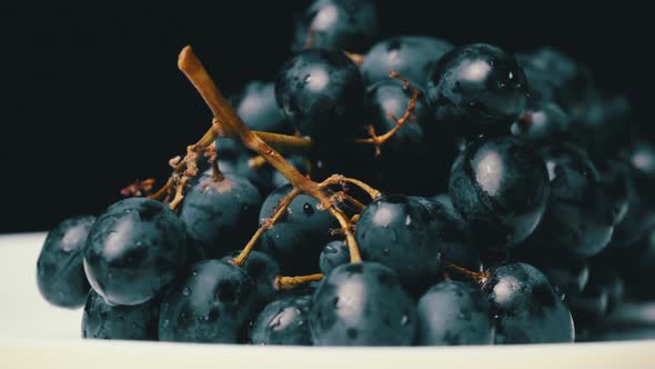 A Bunch of Blue Wet Grapes Spinning Slowly