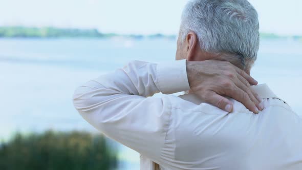 Mature Man Massaging Neck and Shoulders, Aging Health Problem, Painful Injury