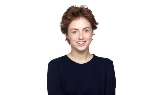 Portrait of Cheerful Woman in Black Sweatshirt Smiling on Camera with Playful and Flirty Look