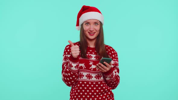 Adult Teen Girl in Christmas Sweater Looking Smartphone Display Sincerely Rejoicing Win Success Luck