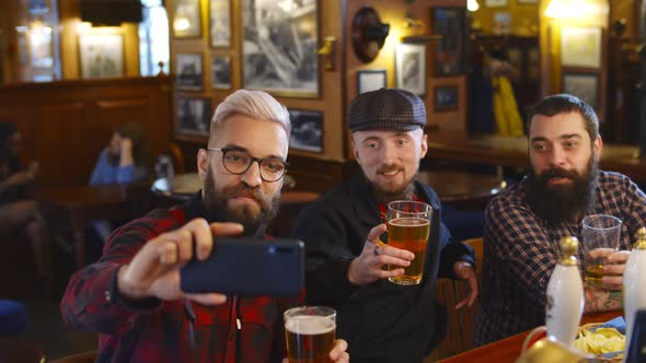 Group of Young Male Friends Taking Selfies at Beer Pub