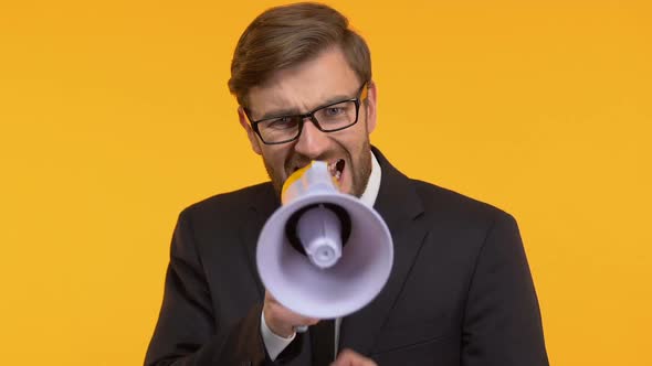 Annoyed Man Screaming Into Megaphone, Trying to Convey His Opinion to Others