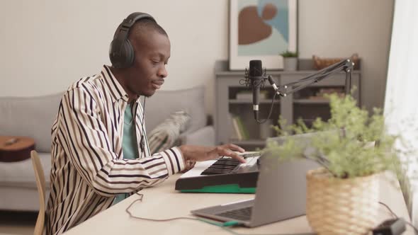 African Man Making Music in Studio