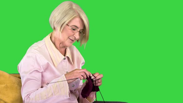 Senior Knitting on a Chair on a Green Screen Chroma Key