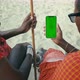 Masai Tribe Men Looking at the Smartphone Green Screen in the Front of Desert - VideoHive Item for Sale