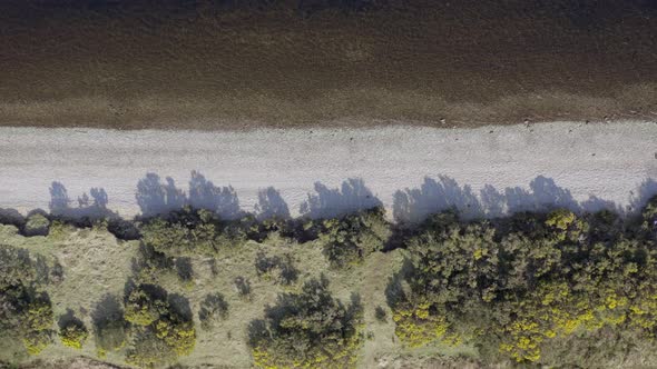 Bird's Eye View of Empty Pebble Shores of a Lake Aerial Flyover