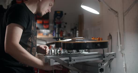 Guitar Tech Mounts the Electric Guitar on the Jig at the Musical Instruments Repairing Shop 60p 10